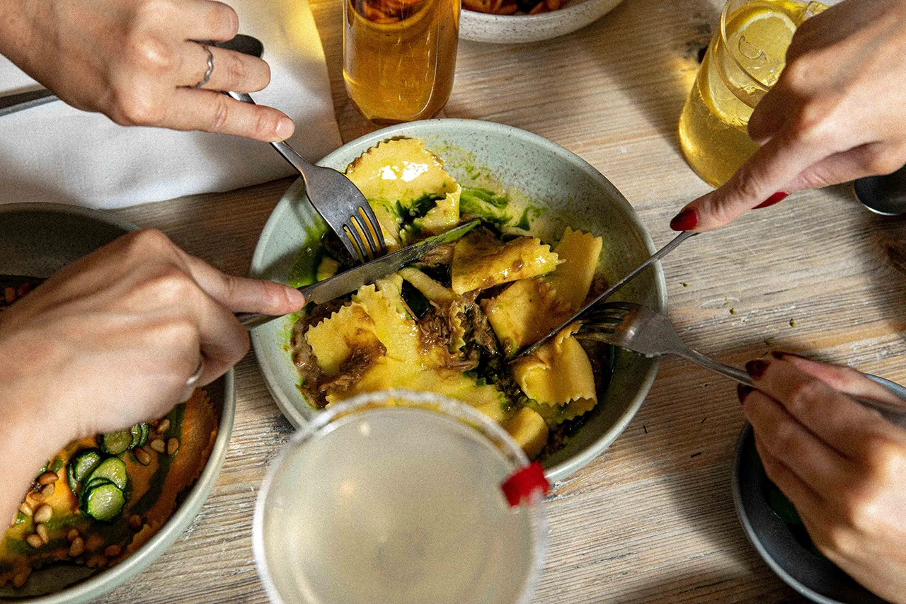two people sharing fresh pasta