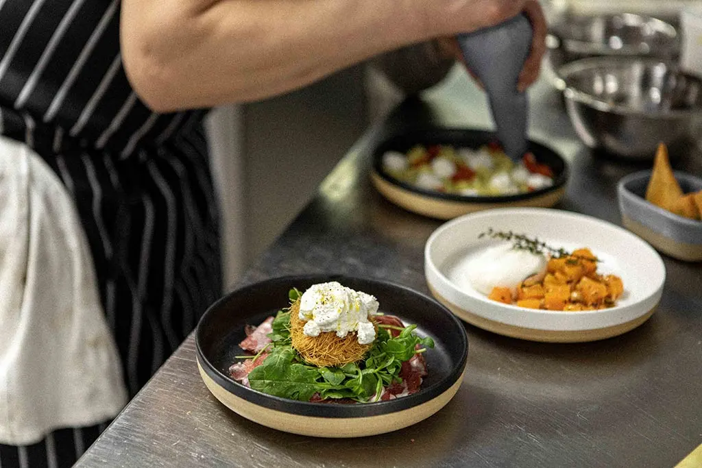 Chef plating up seasonal dishes